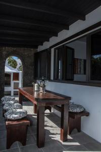 a wooden table and benches on a patio at Casa Tahiche - Jacuzzi, WIFI & BBQ in Tahiche