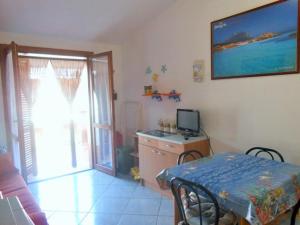 a living room with a table and a television in it at Casa Relax in Villasimius