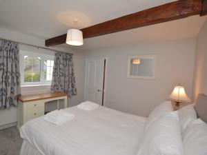 Cama ou camas em um quarto em Pengarreg Fawr