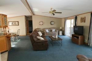 a living room with a couch and a tv at Island Club #98 in Put-in-Bay