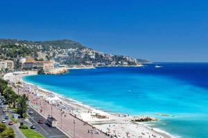 a view of a beach with people and the ocean at Studio With Swimming Pool 80 meters near the beach in Nice