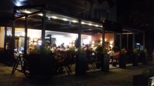 a group of people sitting at a restaurant at night at Septemvri 7 in Kavadarci