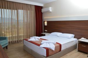 Postel nebo postele na pokoji v ubytování Sunway Club Otel