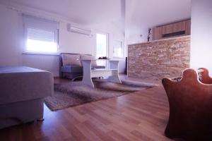 ein Wohnzimmer mit einem Sofa und einem Tisch in der Unterkunft Apartments Aldi in Mostar