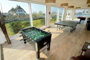 a room with a pool table and ping pong ball at mönchgut living & spa in Gager
