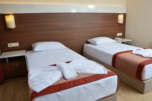 Postel nebo postele na pokoji v ubytování Sunway Club Otel