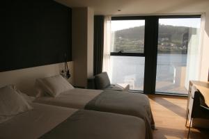 Postel nebo postele na pokoji v ubytování Hotel U Viveiro