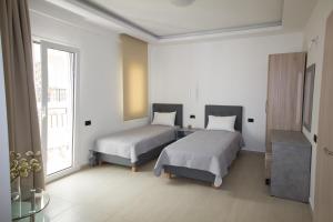 Ліжко або ліжка в номері Xenia Stalis Apartments
