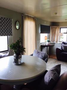 a living room with a table and a couch at Estuary View Caravans in Alnmouth