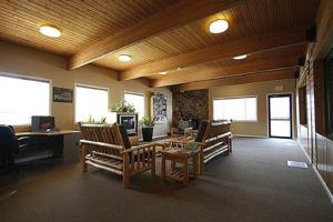 a lobby with chairs and a desk in a building at Akiskinook Resort on Lake Windermere - 1 Bedroom Condo - Sleeps 4 - Indoor Pool - Hot Tub - Sandy Beach - Hot Springs - Golf - 12 Courses - Walk to Town - Shopping - Dining - Local Pubs in Invermere