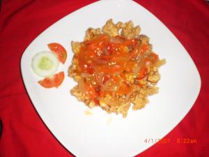 a white plate with food on a red table at D'Made Guest House in Banyuwedang