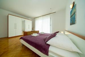 Posteľ alebo postele v izbe v ubytovaní Apartments L&L