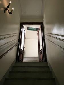 a stairway leading up to an open door in a building at La Boca B&B in Buenos Aires