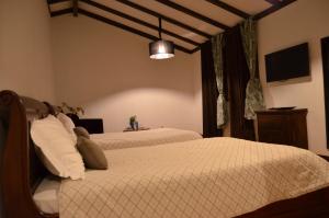 a bedroom with two beds in a room at Quinta da Amoreira in Covilhã +62 photos