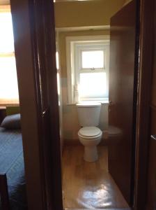 a bathroom with a toilet and a window at Victoria Hotel Blackpool in Blackpool
