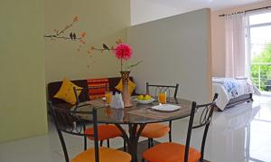 a dining room with a table with orange chairs at Ocean Dreams Galapagos in Puerto Ayora +17 photos