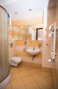 a bathroom with a sink and a toilet at Noclegi M4 in Żyrardów