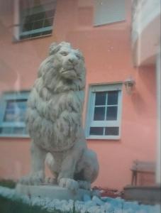 a statue of a lion in front of a building at Angelina in Baiersbronn