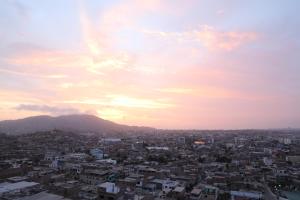 a view of a city at sunset at Edificio Juana Chorrillos in Lima