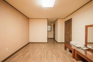 an empty room with a desk and a door at Daea Ulleung Resort in Ulleung