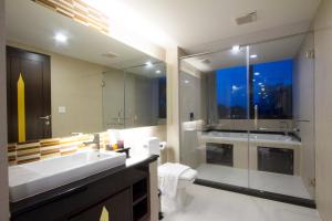 a bathroom with a sink and a toilet and a window at Royal Thai Pavilion Jomtien Hotel in Jomtien Beach +106 photos