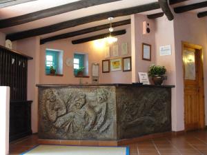 a large stone counter in a room with a wall at Hotel Scintilla in San Teodoro