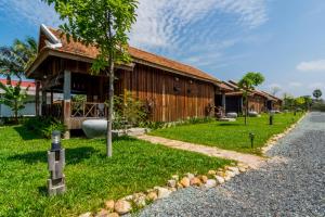 a house with a gravel road in front of it at Kampot River Residence in Kampot