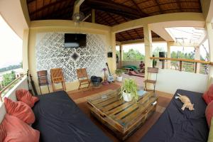 a living room with a couch and a table at Karma Traders Kampot in Kampot
