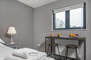 a bedroom with a bed and a table with stools at Paddock Drive in Winchester