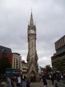 a clock tower in a city with a crowd of people at Comfort Guest House in Leicester