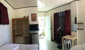 a room with a kitchen and a living room at Reynaldo's Upstairs in Puerto Galera