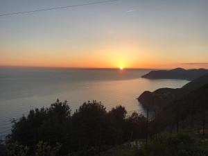 a sunset over a body of water at Albergo Luna di Marzo in Volastra