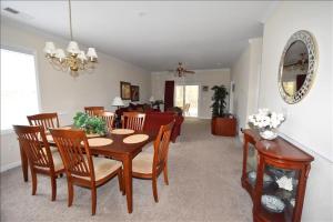a dining room and living room with a table and chairs at 1011 Willow Bend Condo in North Myrtle Beach