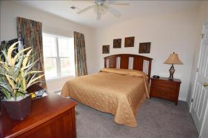 a bedroom with a bed and a dresser and a window at 1011 Willow Bend Condo in North Myrtle Beach +8 photos