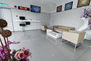 a waiting room with couches and flowers in a hospital at Hotel 99 Kepong in Kuala Lumpur