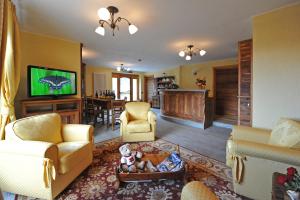 a living room filled with furniture and a flat screen tv at Gresil Residence in Champoluc