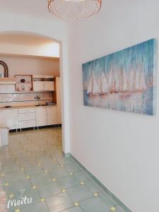 a room with a painting of sailboats on the wall at Apartment Anita 1 in Rijeka