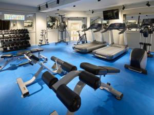 a gym with several treadmills and cardio machines at Grand Hotel Terminus in Bergen