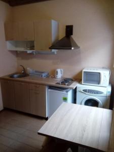 a small kitchen with a stove and a microwave at Holiday home in Ogre