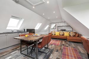 a kitchen and living room with a wooden table and chairs at Paddock View in Winchester