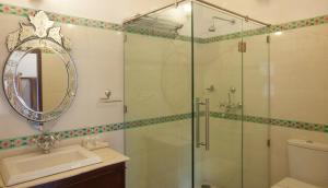 a bathroom with a glass shower and a sink at Lake Pichola Hotel in Udaipur