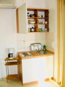 a kitchen with a sink and a counter top at Apartments Ruza in Kaštela