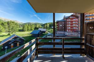 a balcony with a view of a building at Noemys Castor & Pollux in Risoul