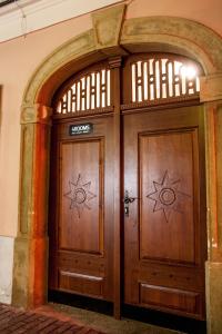 a door that is open to a room with a wooden door at 4Rooms in Maribor