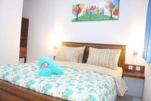 a bedroom with a bed with a stuffed animal on it at JS Guest House in Seminyak