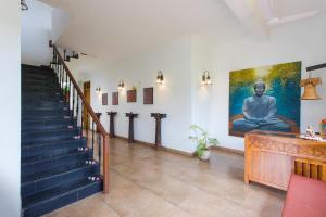 a living room filled with furniture next to a stair case at Heritage Resort Hampi in Hampi