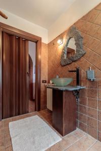a bathroom with a sink and a mirror at Palmento House Amazing View and Private Mini SPA in Piedimonte Etneo