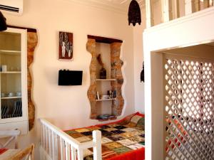 a childs bedroom with a bed and a mirror at Bright Sun Villas in Halki
