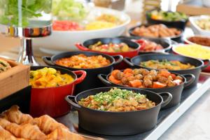 a buffet of different types of food on a table at Candeo Hotels Kobe Tor Road in Kobe