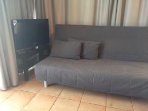 a couch in a living room with a flat screen tv at Teris Appartment in Preveza